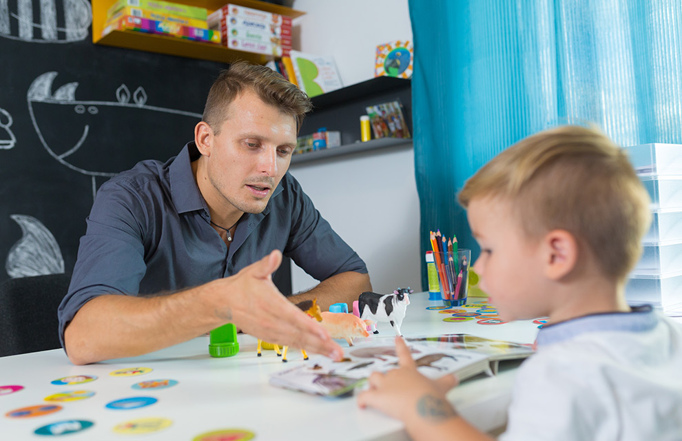 male teacher evaluates a child